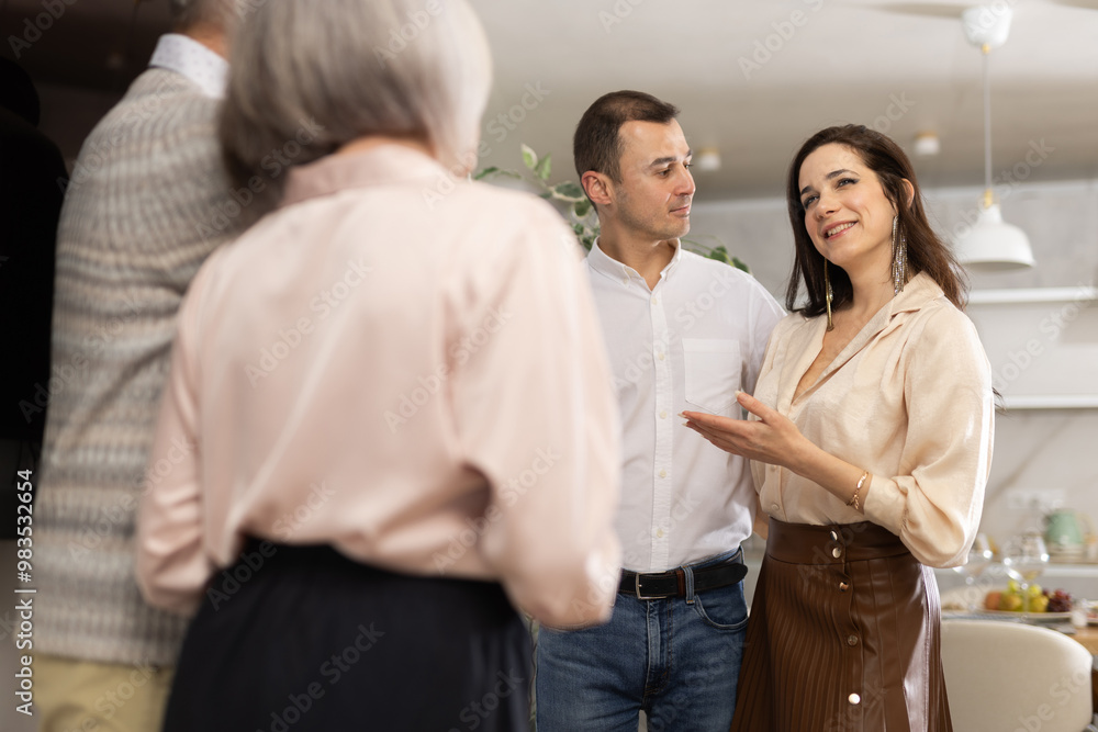 Fototapeta premium Middle-aged woman introduces her boyfriend to elderly parents. Upset parents look disapprovingly at their daughter and her chosen one.