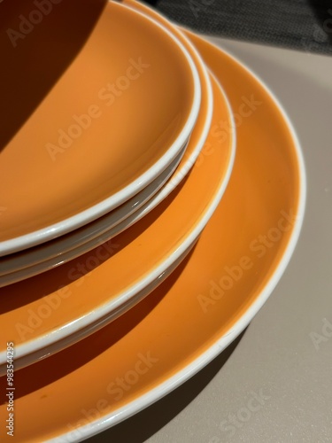 Foto Stack of orange plate on table