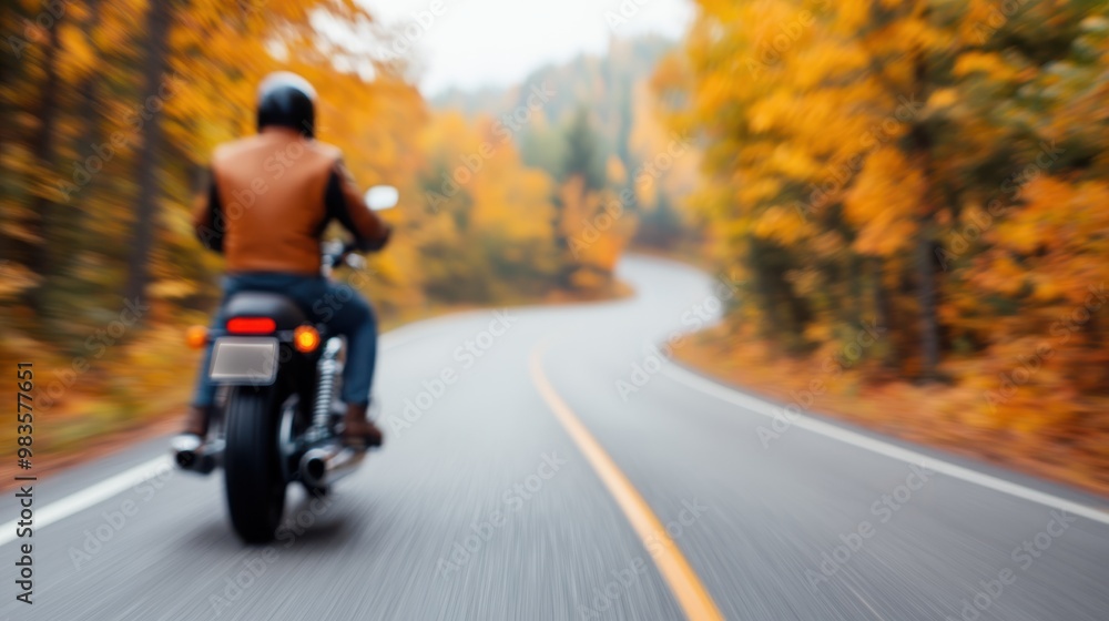 A motorcyclist wearing a helmet and jacket is riding a motorcycle on a winding road surrounded by vibrant autumn foliage, creating a picturesque and serene scene. A motorcyclist wearing a helmet and jacket is riding a motorcycle on a winding road surrounded by vibrant autumn foliage, creating a picturesque and serene scene.