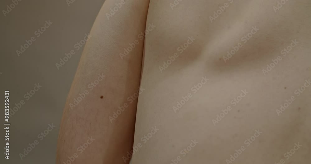 Detailed shot of a male's bare shoulder, highlighting skin texture. Detailed shot of a male's bare shoulder, highlighting skin texture.