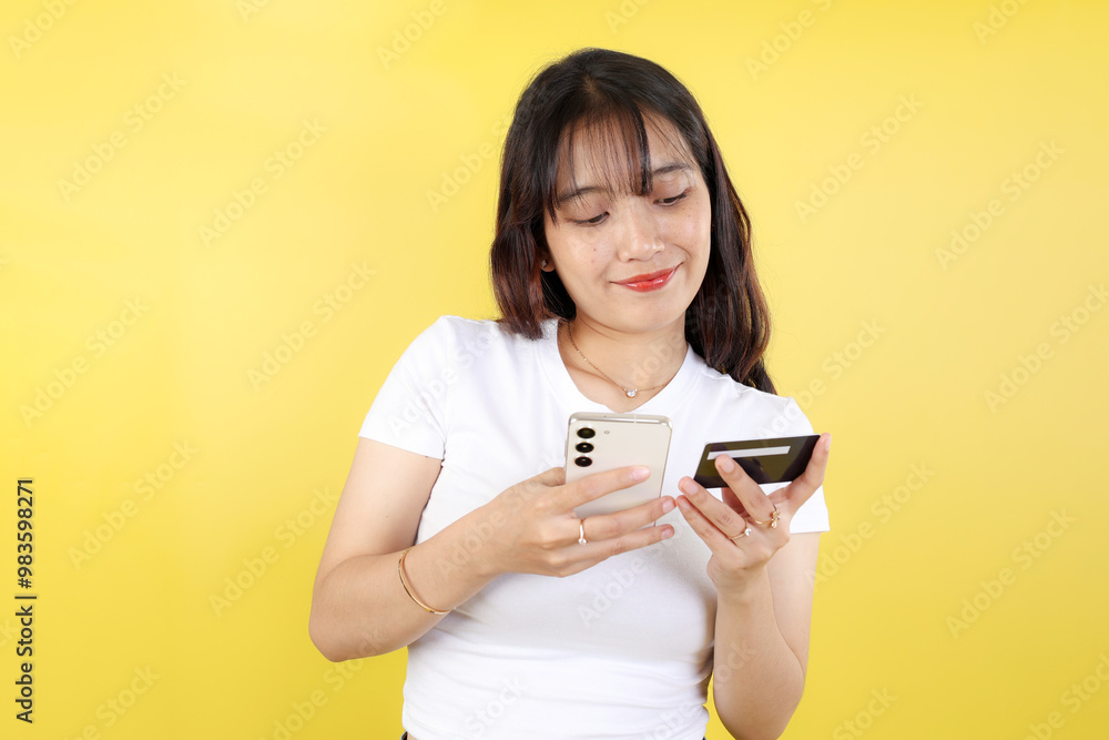 Portrait of Happy Indonesian Woman Using Black Credit Card and Smartphone App Portrait of Happy Indonesian Woman Using Black Credit Card and Smartphone App
