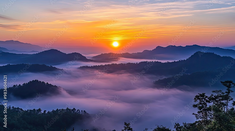 Fototapeta premium A stunning sunrise over misty mountains, casting warm hues on a serene landscape, perfect for nature lovers and outdoor enthusiasts.