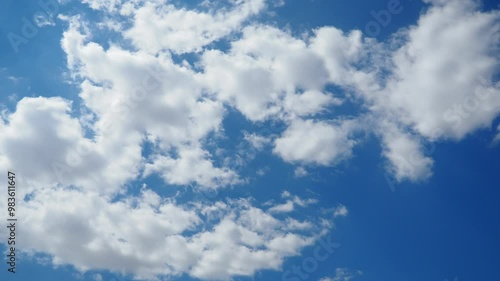 Beautiful white clouds in the sunny blue sky. Volumetric light effect. Convection in the troposphere. Real time slow motion. Cumulus clouds low-level, puffy, cotton-like, fluffy Cumulonimbus photo