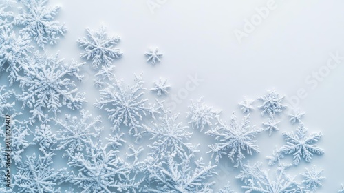 Delicate snowflakes create an exquisite pattern against a soft blue background, highlighting winter's beauty and serenity.