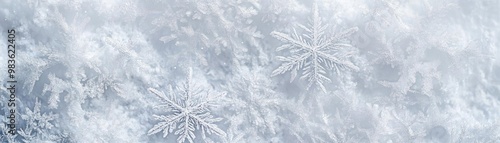 Close-up of delicate and intricate snowflakes on a soft, white background, perfect for winter themes and seasonal designs.