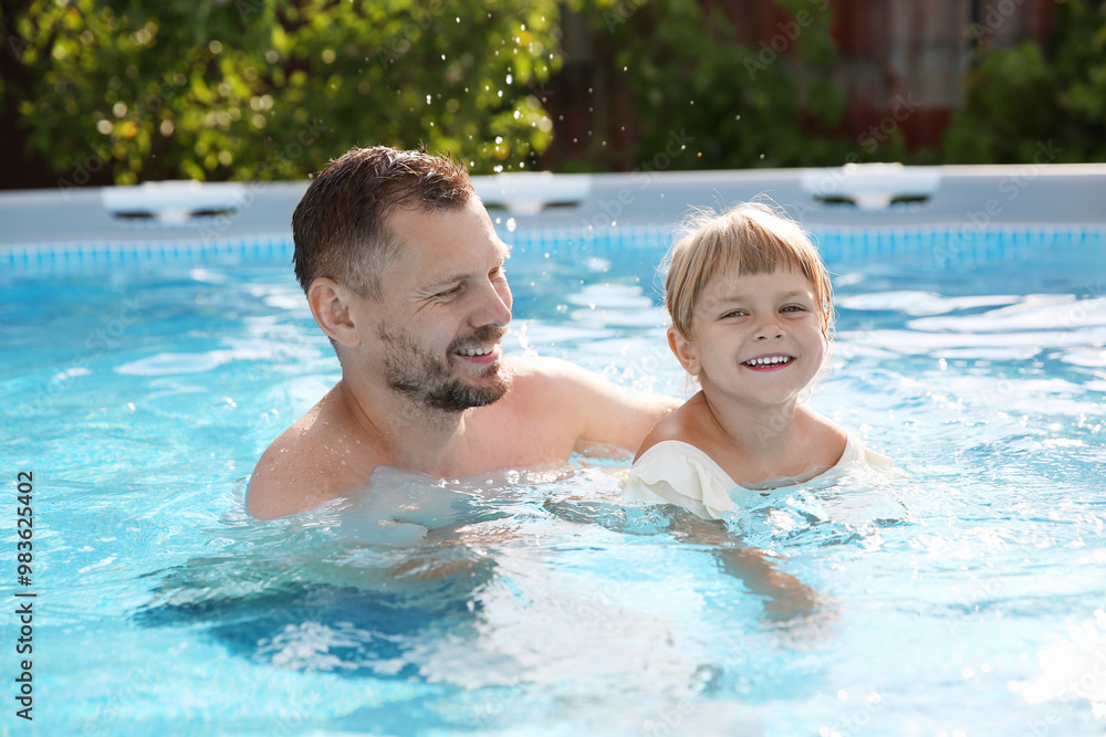 Happy father having fun with his daughter in swimming pool Happy father having fun with his daughter in swimming pool