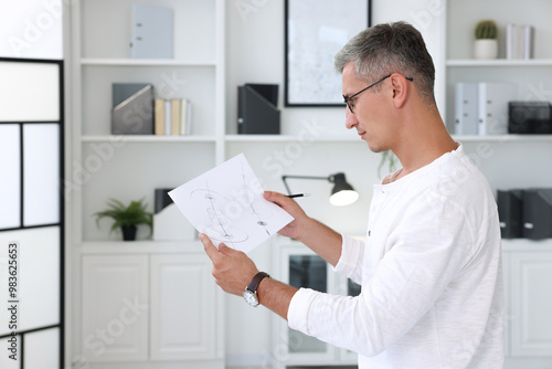 Wallpaper Mural Architect holding paper sheet with engineering drawing in office Torontodigital.ca