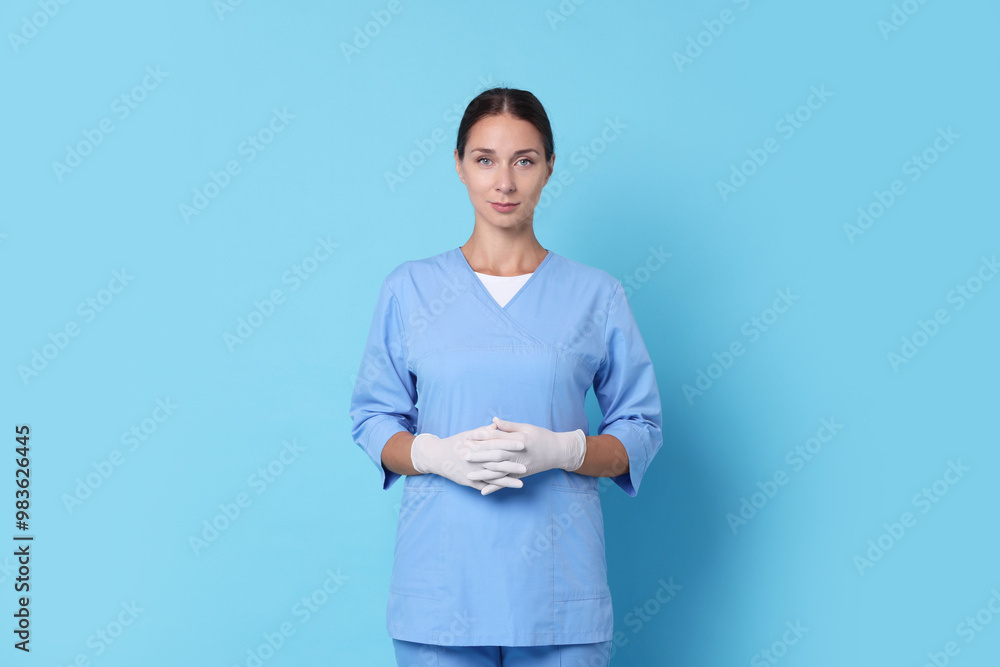 Nurse in medical uniform on light blue background Nurse in medical uniform on light blue background