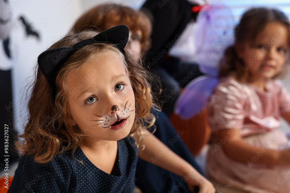 Fototapeta premium Funny children wearing costumes for Halloween celebration indoors, selective focus