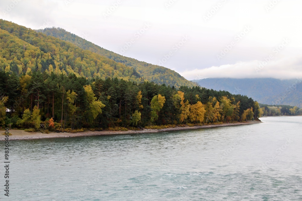 Scenic river view with lush green hills and autumn foliage. Scenic river view with lush green hills and autumn foliage.
