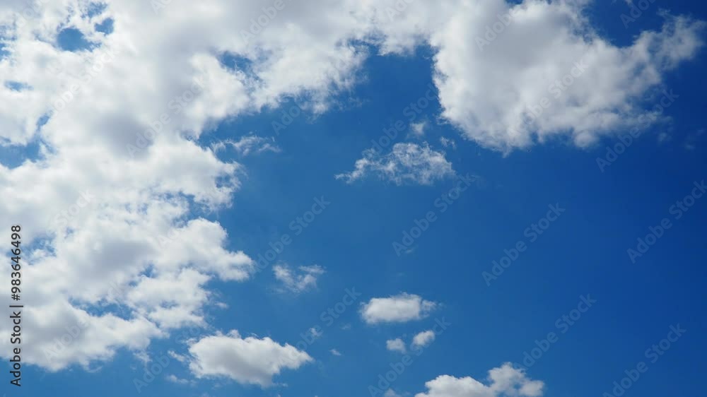 Beautiful white clouds in the sunny blue sky. Volumetric light effect. Convection in the troposphere. Real time slow motion. Cumulus clouds low-level, puffy, cotton-like, fluffy Cumulonimbus Beautiful white clouds in the sunny blue sky. Volumetric light effect. Convection in the troposphere. Real time slow motion. Cumulus clouds low-level, puffy, cotton-like, fluffy Cumulonimbus