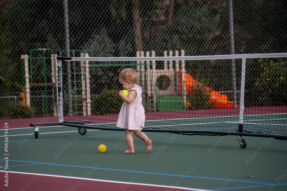 Obraz premium playing pickleball with a baby girl