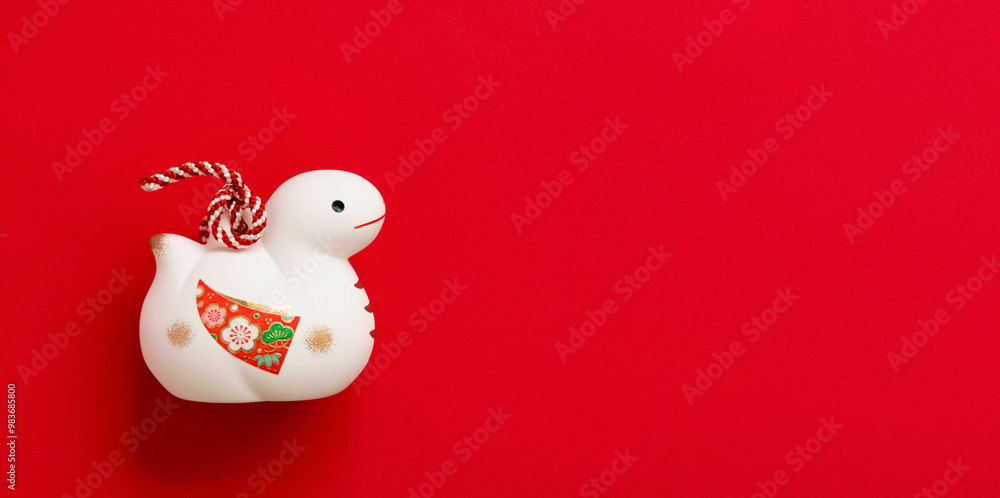 Japanese new year material. Zodiac Snake. Snake ornament on the red background. 日本のお正月素材。干支の巳(ヘビ)。赤背景上の巳の置物 Japanese new year material. Zodiac Snake. Snake ornament on the red background. 日本のお正月素材。干支の巳(ヘビ)。赤背景上の巳の置物