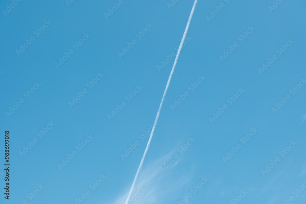 青空に走る長い飛行機雲 旅行・航空機・アウトドアの背景 青空に走る長い飛行機雲 旅行・航空機・アウトドアの背景