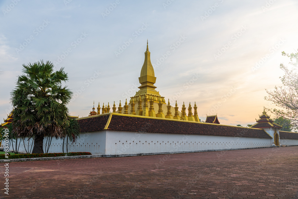 Naklejka premium Pha That Luang ( Great Stupa )is a gold-covered large Buddhist stupa in the centre of the city of Vientiane, Laos at sunset.