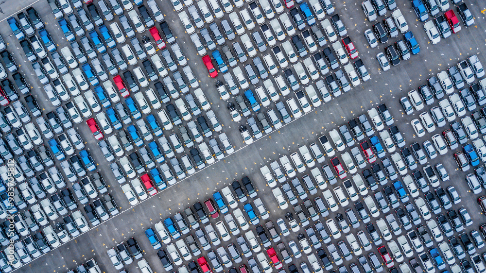 Aerial view new cars lined up in the port for import and export, Top view of new cars lined up automobile factory global logistic import export, New cars logistic to dealership for sale.
