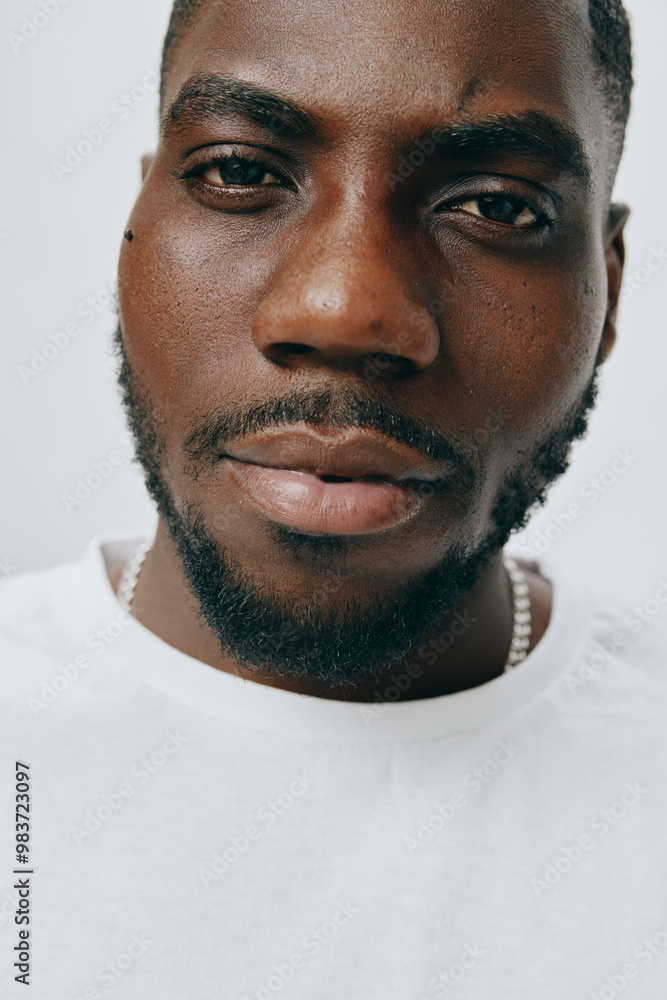 Obraz premium Close up portrait of a confident young man with a fresh look, showcasing smooth skin and stylish facial hair, set against a neutral background