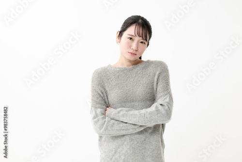 腕組みをして不機嫌な女性 photo