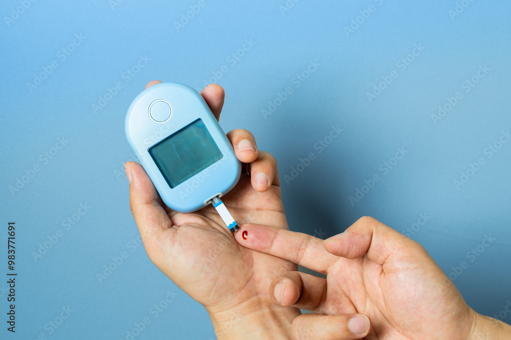 hand of people check diabetes and high blood glucose monitor with digital pressure gauge. Healthcare and Medical concept hand of people check diabetes and high blood glucose monitor with digital pressure gauge. Healthcare and Medical concept