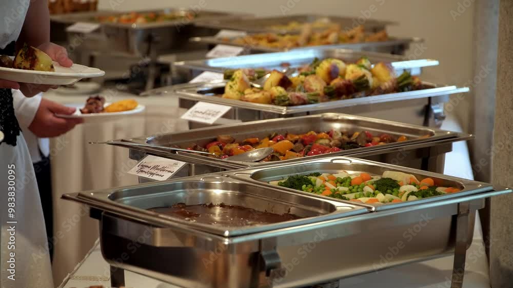 buffet guests putting food on plates buffet guests putting food on plates