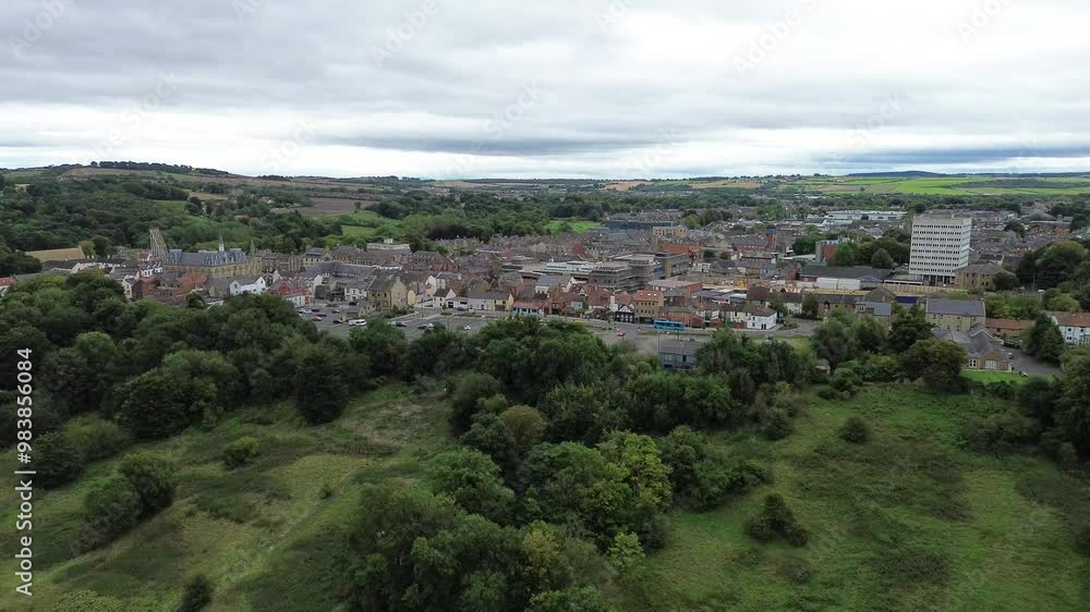 Rising drone shot of County Durham town centre, Bishop Auckland surrounded by fields - UK Rising drone shot of County Durham town centre, Bishop Auckland surrounded by fields - UK