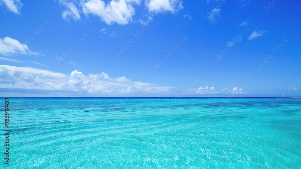 A beautiful scene of the blue ocean against the blue sky background. The ocean stretches out as far as the eye can see, with its surface glistening in the sunlight A beautiful scene of the blue ocean against the blue sky background. The ocean stretches out as far as the eye can see, with its surface glistening in the sunlight