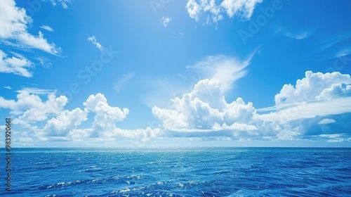 A beautiful scene of the blue ocean against the blue sky background. The ocean stretches out as far as the eye can see, with its surface glistening in the sunlight photo