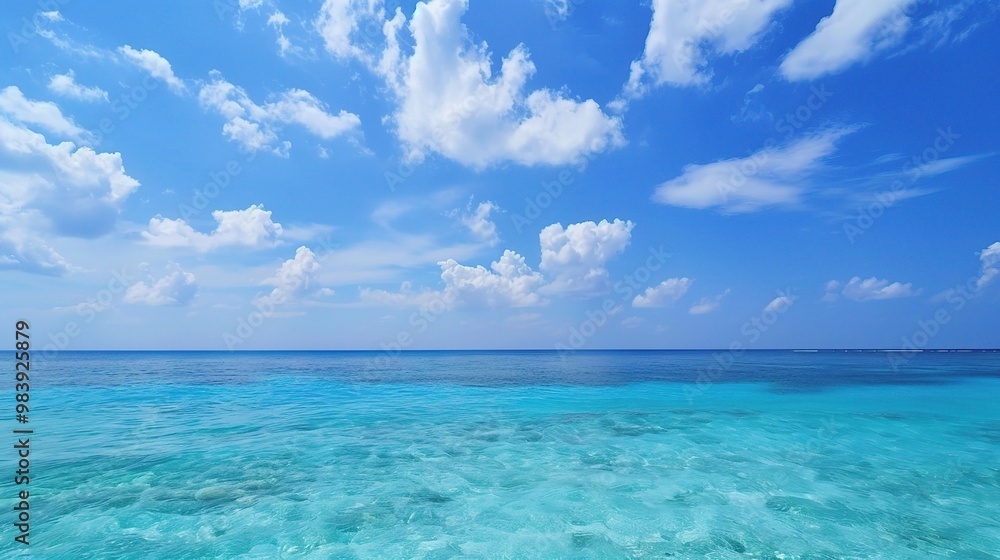 A beautiful scene of the blue ocean against the blue sky background. The ocean stretches out as far as the eye can see, with its surface glistening in the sunlight A beautiful scene of the blue ocean against the blue sky background. The ocean stretches out as far as the eye can see, with its surface glistening in the sunlight