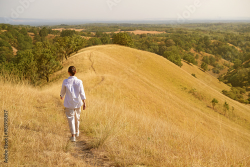 A charming girl enjoys the wind, smile and freedom, sunset and autumn light. Beautiful lady having fun in nature.