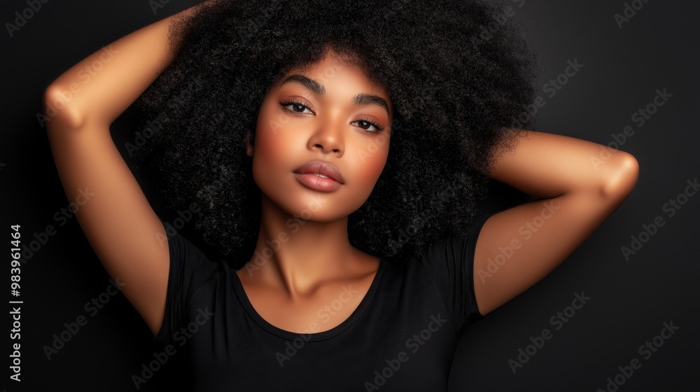 A woman with curly hair is posing for a picture. She has a natural, relaxed expression on her face A woman with curly hair is posing for a picture. She has a natural, relaxed expression on her face