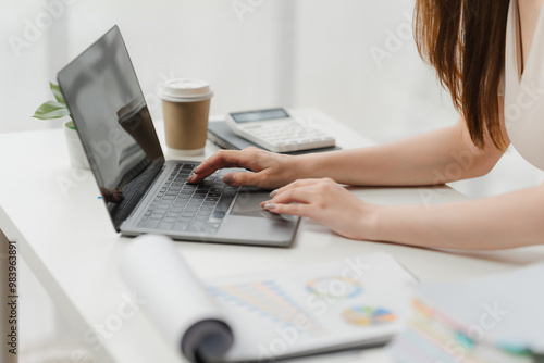 Focused Female Professional Analyzes Data on Laptop