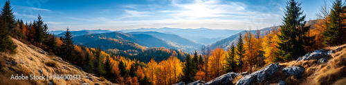 Beautiful autumnal view of the Carpathian Mountains. Autumn leaves on the trees. Rocks on the hilltop.