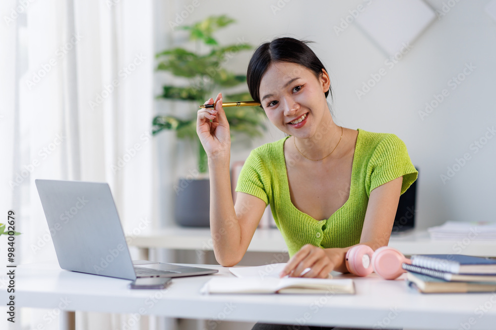 Portrait of happy young asian female office manager employee consultant posing at work desk by laptop looking at camera. young woman entrepreneur sit at workplace use computer Portrait of happy young asian female office manager employee consultant posing at work desk by laptop looking at camera. young woman entrepreneur sit at workplace use computer