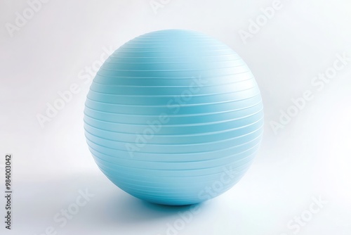  A light blue yoga ball, lying flat against a white background