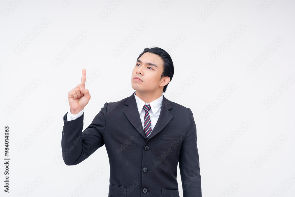 A young asian businessman raising his finger up. realizing he has been duped or scammed. Isolated on a white background. A young asian businessman raising his finger up. realizing he has been duped or scammed. Isolated on a white background.