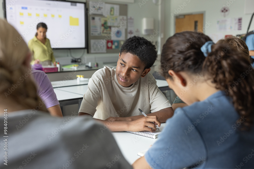 African American boy student looking out of the window in class African American boy student looking out of the window in class