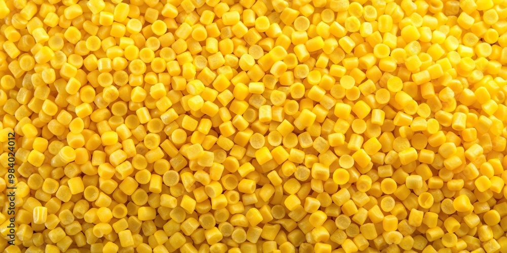 Aerial view of yellow resin pellets used for hot melt adhesives Aerial view of yellow resin pellets used for hot melt adhesives