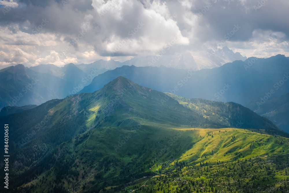 Fototapeta premium Beautiful landscape view of Dolomites meadows and mountains with dramatic sunrays