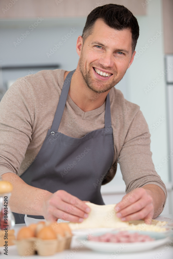 handsome man cooking at home preparing salad in kitchen handsome man cooking at home preparing salad in kitchen