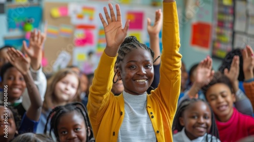 Happy students in a classroom raise their hands enthusiastically. They are eager to learn and engage with their teacher.