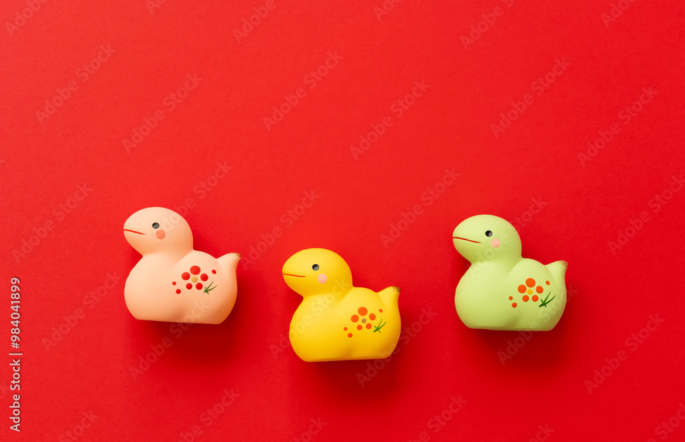 Japanese new year material. Zodiac Snake. Snakes ornament on the red background. 日本のお正月素材。干支の巳(ヘビ)。赤背景上の巳の置物 Japanese new year material. Zodiac Snake. Snakes ornament on the red background. 日本のお正月素材。干支の巳(ヘビ)。赤背景上の巳の置物
