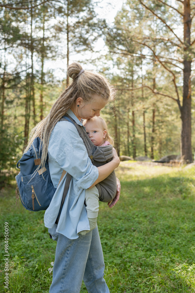 Tender moment between mother and child during forest hike Tender moment between mother and child during forest hike