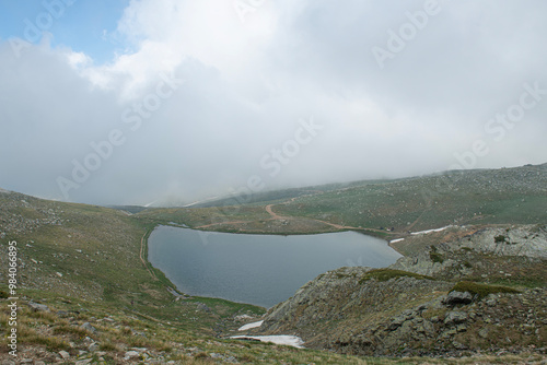 Reflection of clouds in the blue sky in the lake.Reflections in the glacial lake. Reflections on Kilimli lake. Lakes on top of Uludağ, Kilimli Lake, Bursa, Türkiye. photo