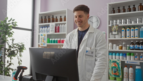 Handsome young hispanic man working at a computer in an indoor pharmacy shop, surrounded by medicine and health products.