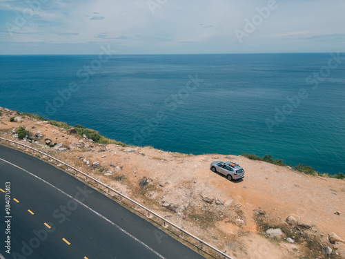 Wallpaper Mural Aerial view of SUV car arriving on beach with beautiful sea view. Royalty high-quality free stock image top view adventure road trip between mountain rock and ocean. Driving road along, traveling Torontodigital.ca