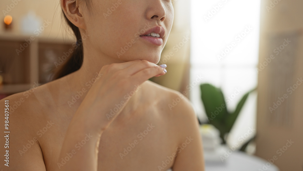 Young beautiful chinese woman at a spa salon relaxing in an indoor wellness center Young beautiful chinese woman at a spa salon relaxing in an indoor wellness center