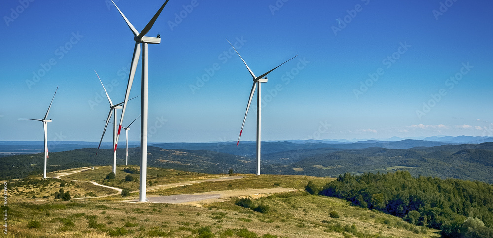 A breathtaking view of a wind electricity station set against the majestic Carpathian Mountains. A breathtaking view of a wind electricity station set against the majestic Carpathian Mountains.