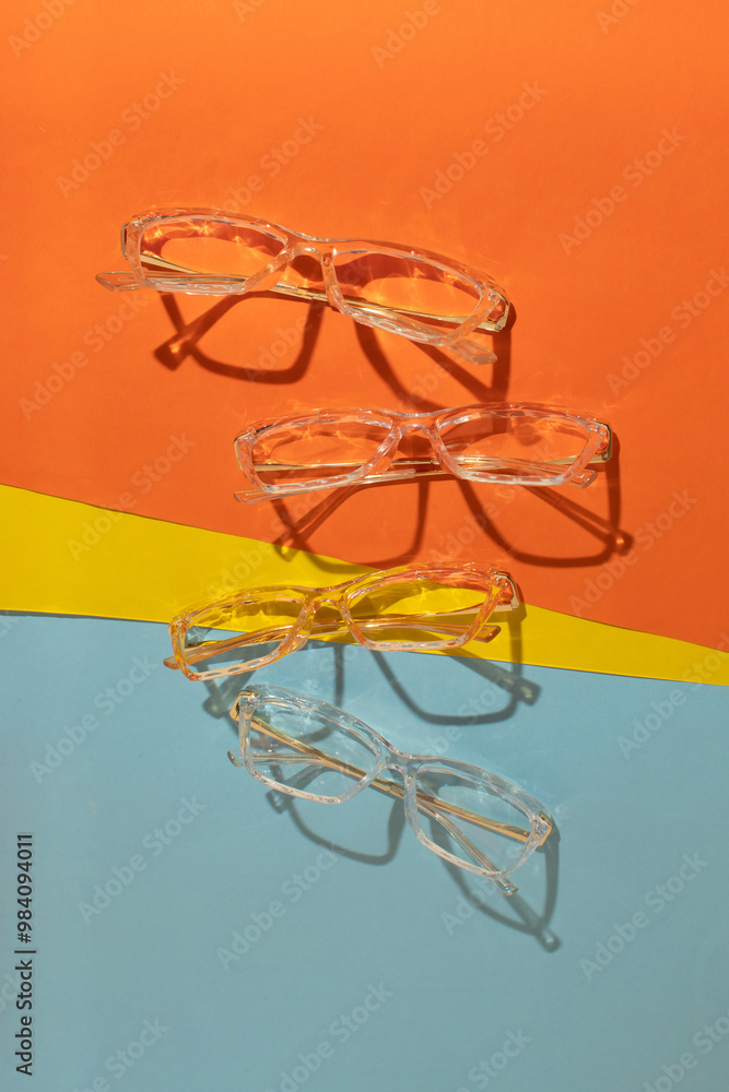 Transparent glasses on colorfull background. Minimal creative concept. Flat lay. Transparent glasses on colorfull background. Minimal creative concept. Flat lay.