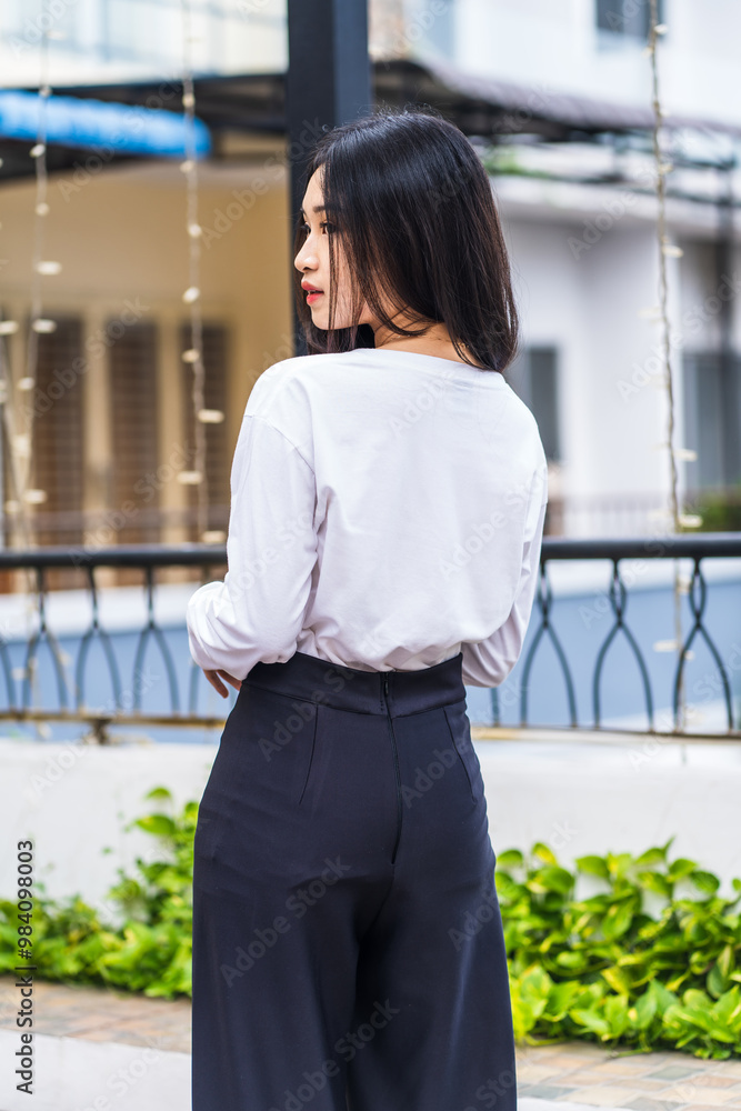 Fototapeta premium Woman's Back in White Blank Long Sleeve Shirt – Perfect for Mockup and Branding