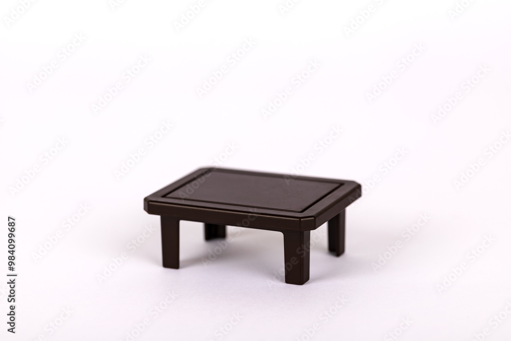 Dark brown toy table, isolated on white background. Concept of everyday elements and furniture Dark brown toy table, isolated on white background. Concept of everyday elements and furniture